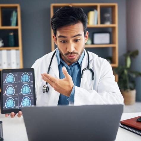 man and doctor on video call, talking and healthcare with telehealth, diagnosis and analysis for care. Male employee, medical professional or surgeon with tablet, brain scans